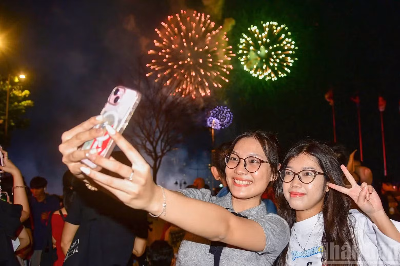 Residents posed for photographs and captured memorable moments beneath the fireworks-lit sky.