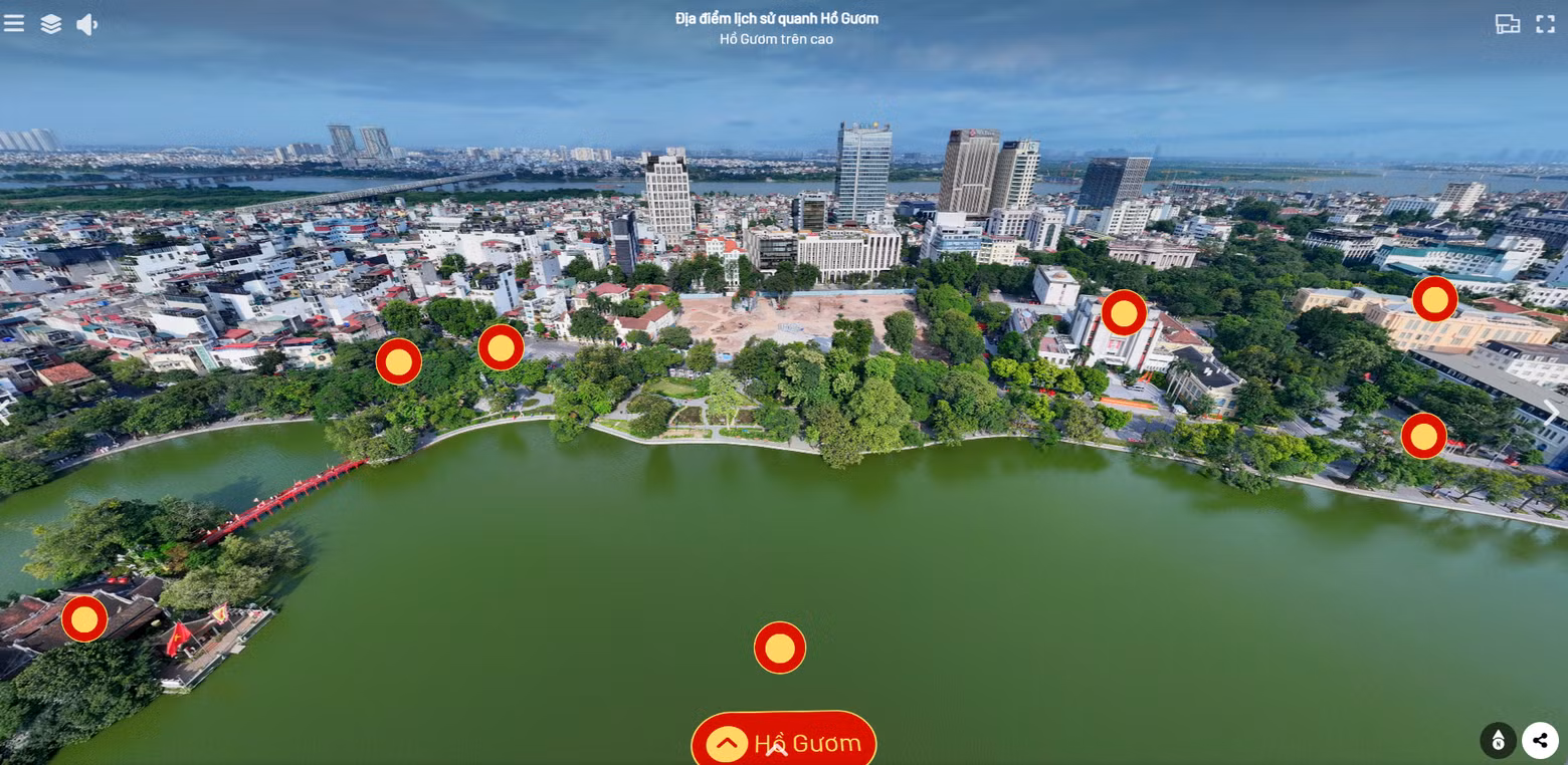 An aerial panoramic view of Hoan Kiem Lake reveals the harmonious blend of lush green spaces and the city's time-honoured architecture.
