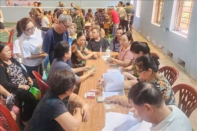 Local people line up at a distribution point in Lang Son province. (Photo: VNA)